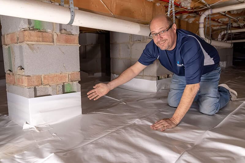 Triangle Reconstruction crew installing a crawl space vapor barrier